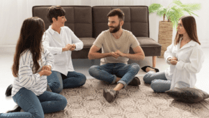 A small group sitting in a circle, engaging in a therapeutic exercise, symbolizing the practice of Internal Family Systems or IFS therapy and its healing power.