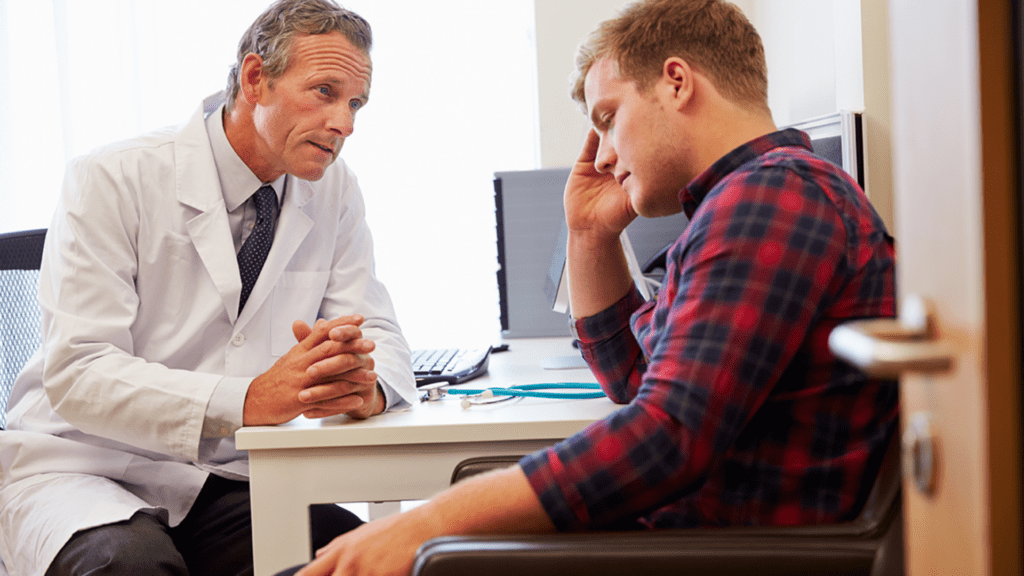 A gay man and a mental health residential treatment professional in an exchange of thoughts during a therapy session.