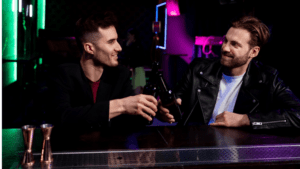 Two gay men enjoying drinks at a bar, representing the social dynamics and pressures of gay nightlife.