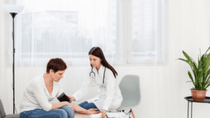 A lesbian person and a medical doctor during a regular medical check-up in a residential treatment.