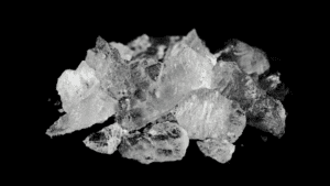 Close-up of crystal meth on a black background, symbolizing the dangers of meth use and its lingering effects in the body.