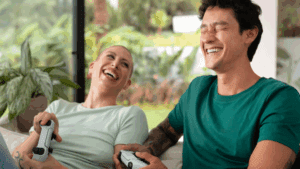 Two queer persons happily playing video games in an inpatient drug rehabilitation center.