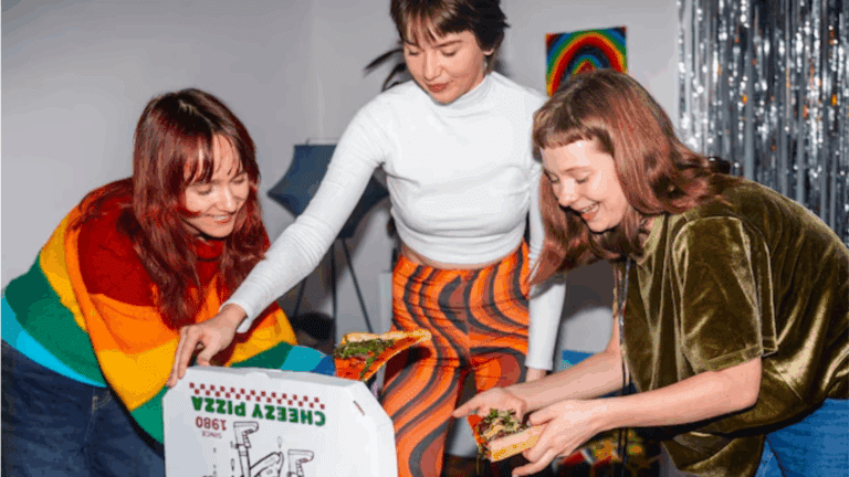 LGBTQ folks happily eating pizza in an LGBTQ-friendly rehab.