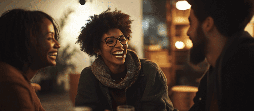 Three Black individuals smiling and enjoying time together in a residential treatment setting, showing community and connection in recovery.