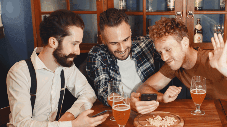 A group of gay friends, having fun while drinking beer in a bar who may have alcohol abuse.