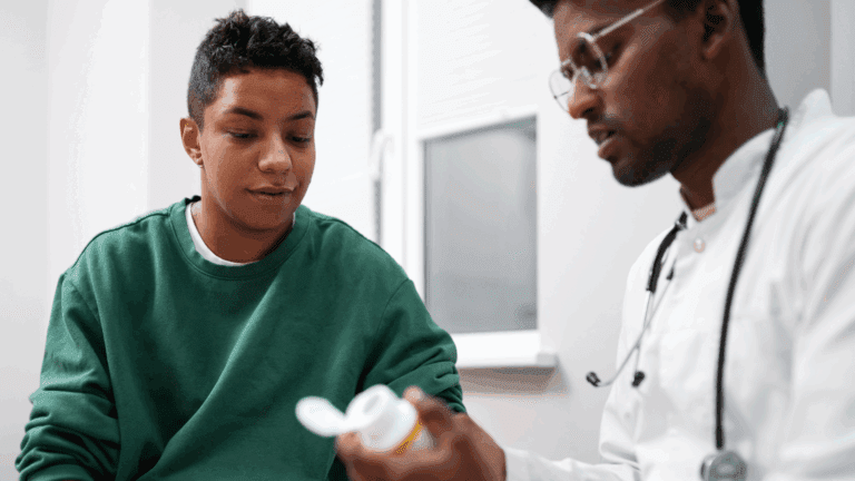 A medical doctor showing a gay person an addiction treatment medicine.