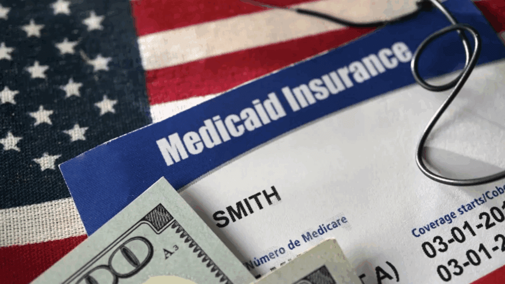 A sample image of a health insurance card along with a flag of the US and dollar bills.