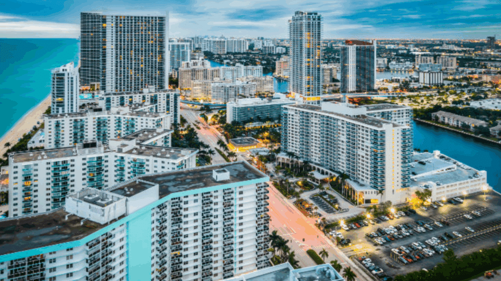 A vibrant aerial view of high-rise buildings and coastal cityscape near Hollywood, Florida