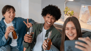 LGBTQ friends smiling and enjoying non-alcoholic drinks as they journey to sobriety.