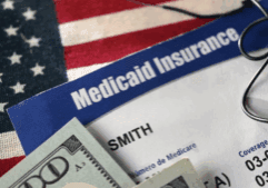 A sample image of a health insurance card along with a flag of the US and dollar bills.