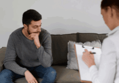 An image of a therapist and a gay person while in detox in an inpatient detox facility.