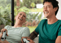 Two queer persons happily playing video games in an inpatient drug rehabilitation center.