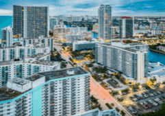 A vibrant aerial view of high-rise buildings and coastal cityscape near Hollywood, Florida