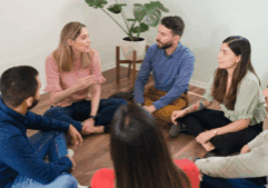 A group of LGBTQ folks during a group therapy in an LGBTQ Drug Treatment rehab.