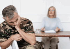 A therapist and a gay veteran seemingly experiencing PTSD episodes during therapy.