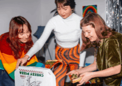LGBTQ folks happily eating pizza in an LGBTQ-friendly rehab.