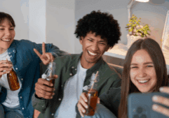 LGBTQ friends smiling and enjoying non-alcoholic drinks as they journey to sobriety.