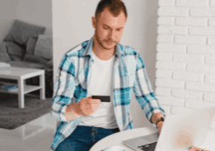 A gay man examining his insurance card.