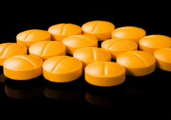 Orange tablets displayed on a surface, used to illustrate an example of the drug, Suboxone.
